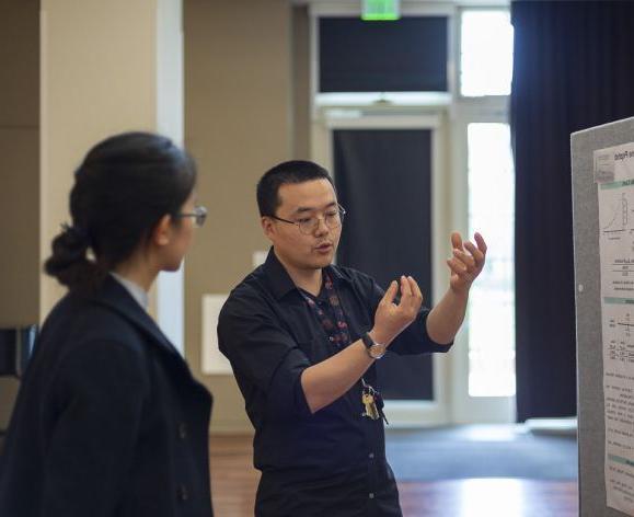 Student presenting a research poster